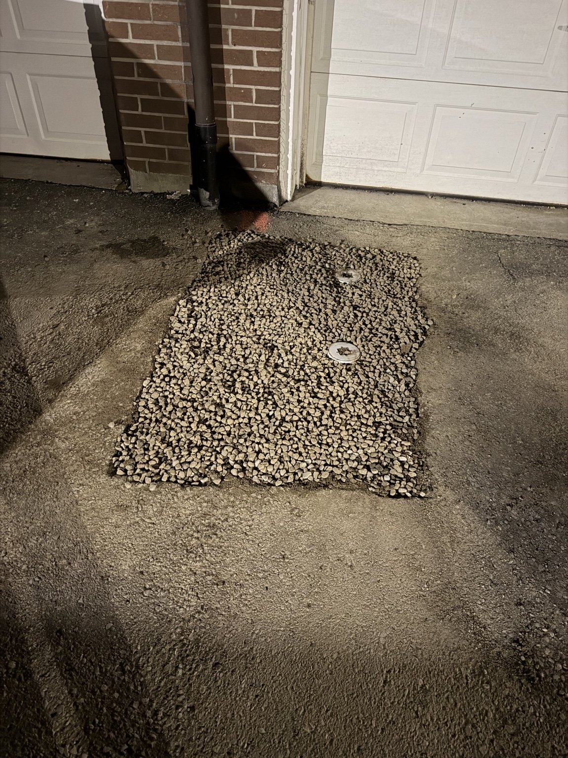 Gravel backfill with two visible access caps
