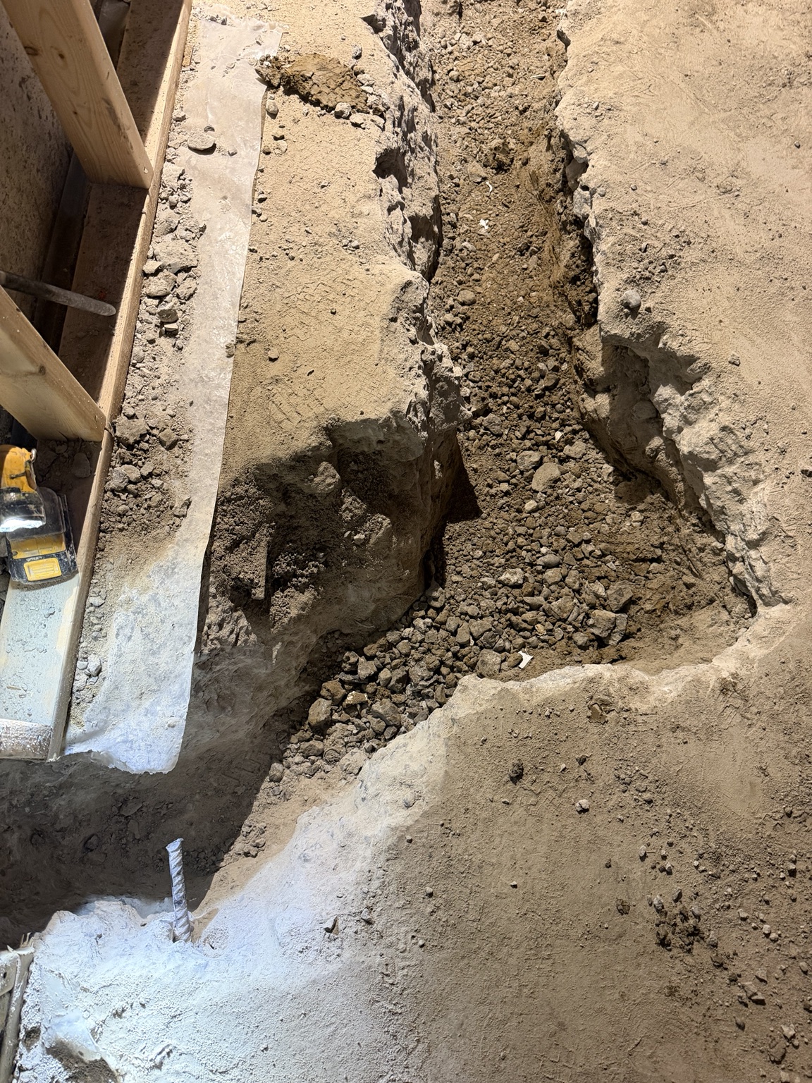 Basement trench prepared for underground drain piping