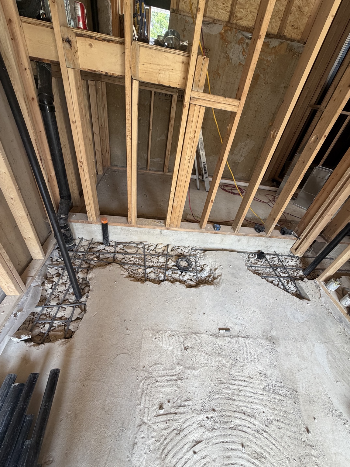 Bathroom floor opening prepared with reinforcing bars