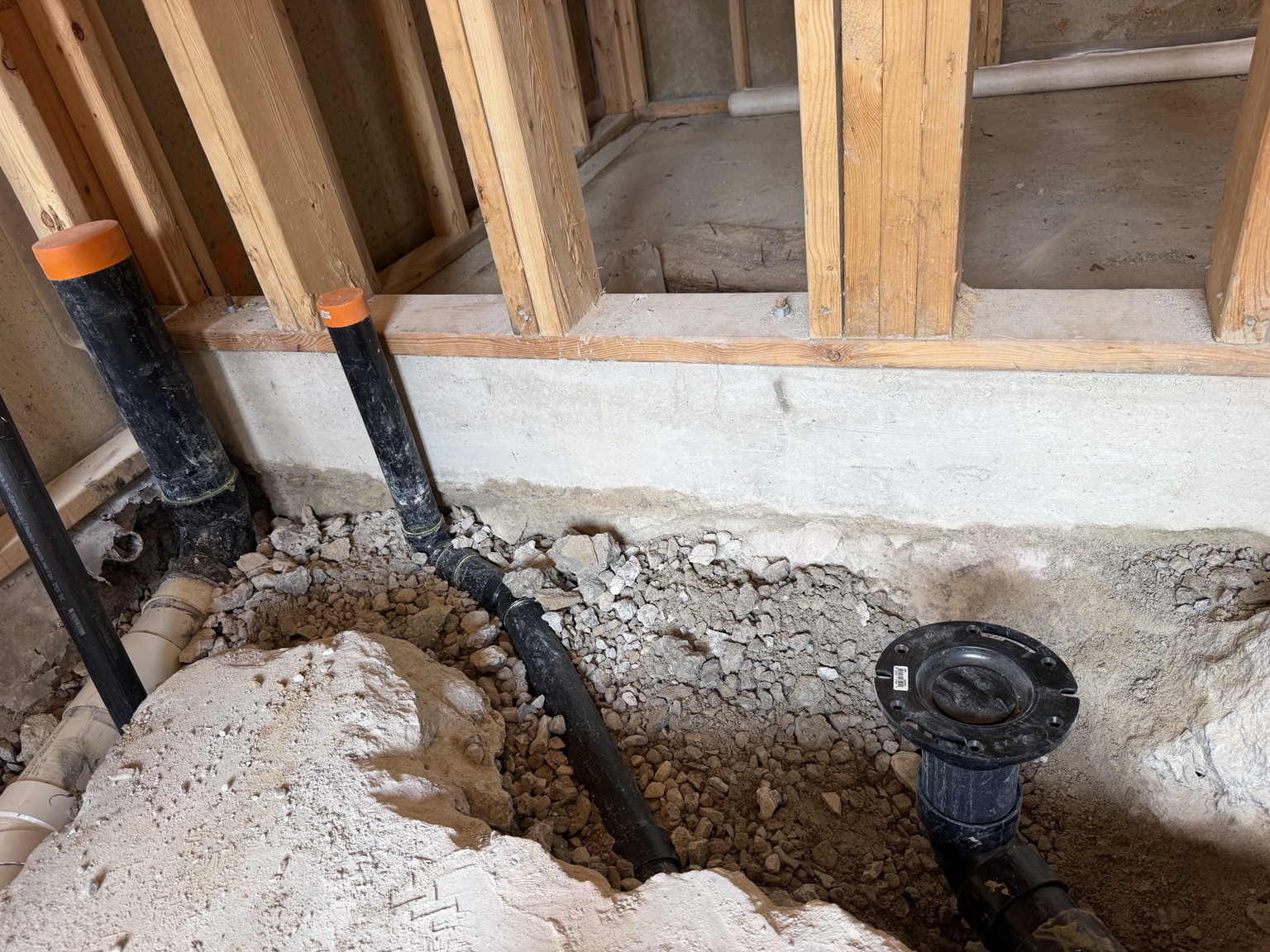 Underground bathroom rough-in for a toilet, shower and washbasin