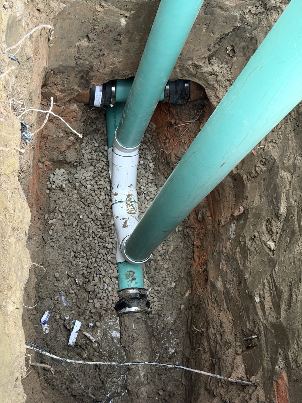 Vertical sewer access risers during installation