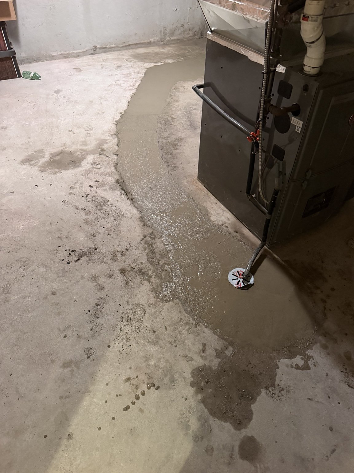 Fresh concrete patch in a basement floor