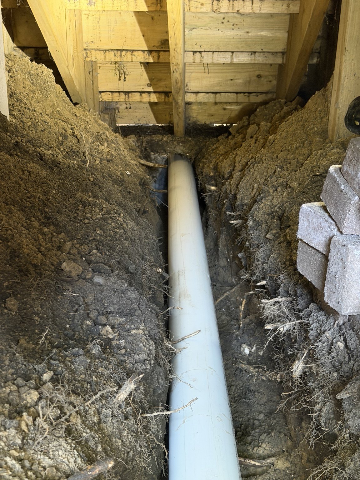 New drain piping beneath the deck