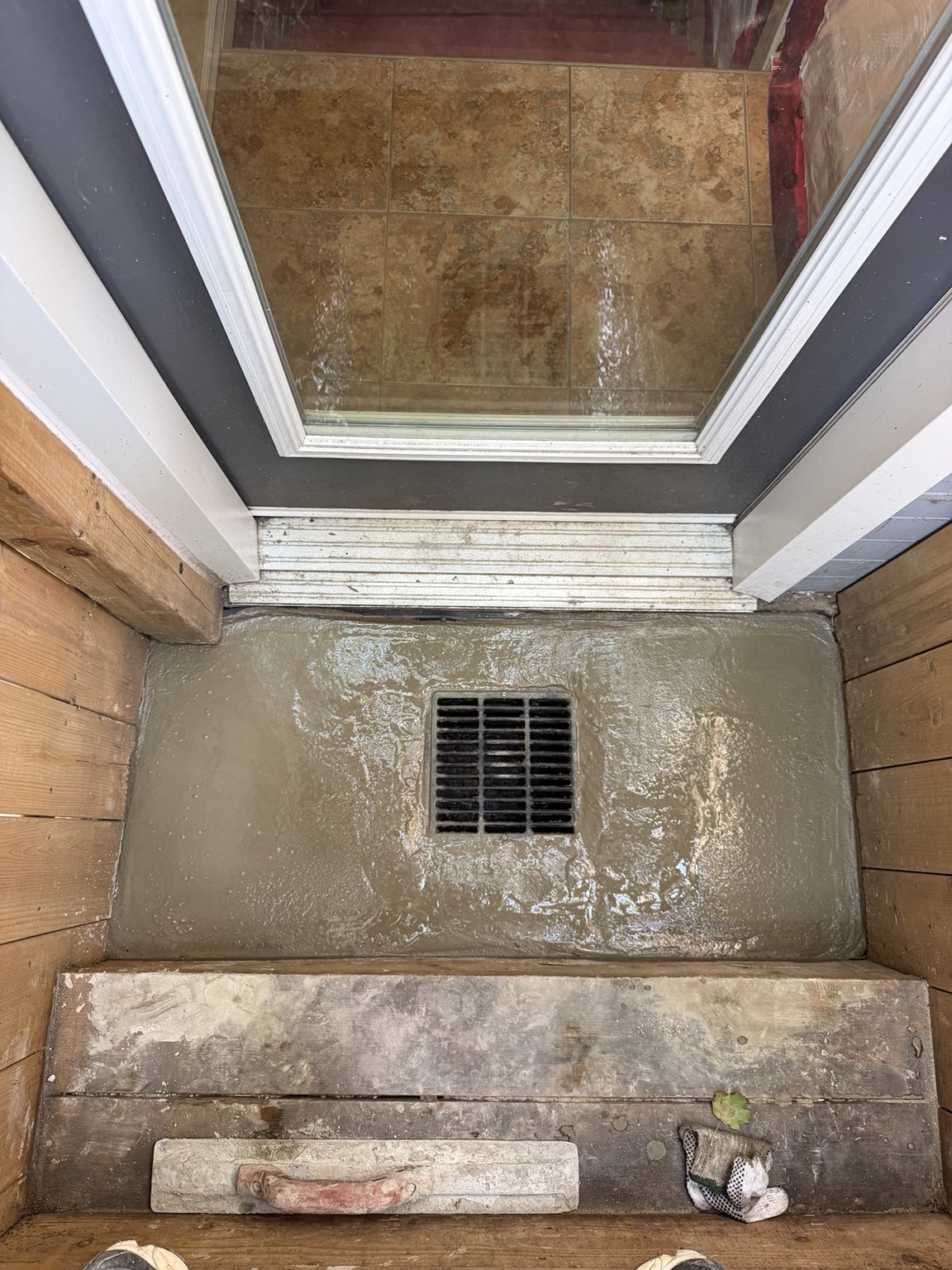 New concrete landing around an exterior entrance drain