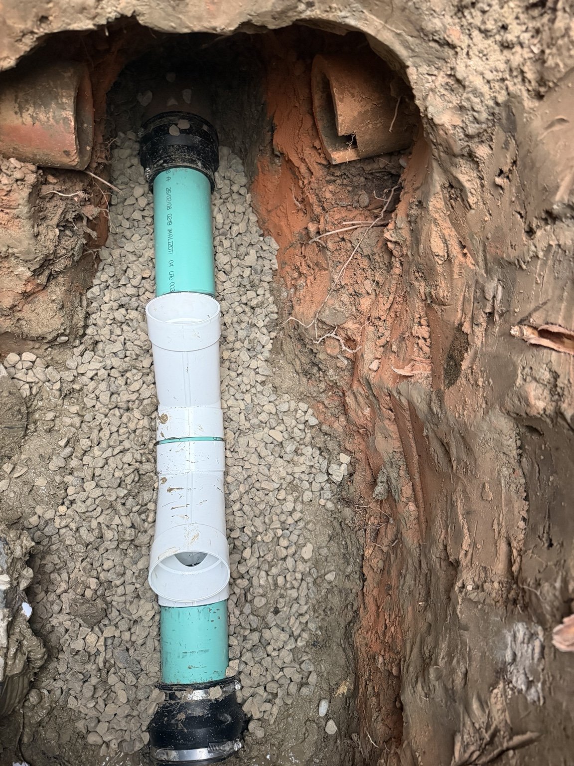 Exposed sewer line in an excavation