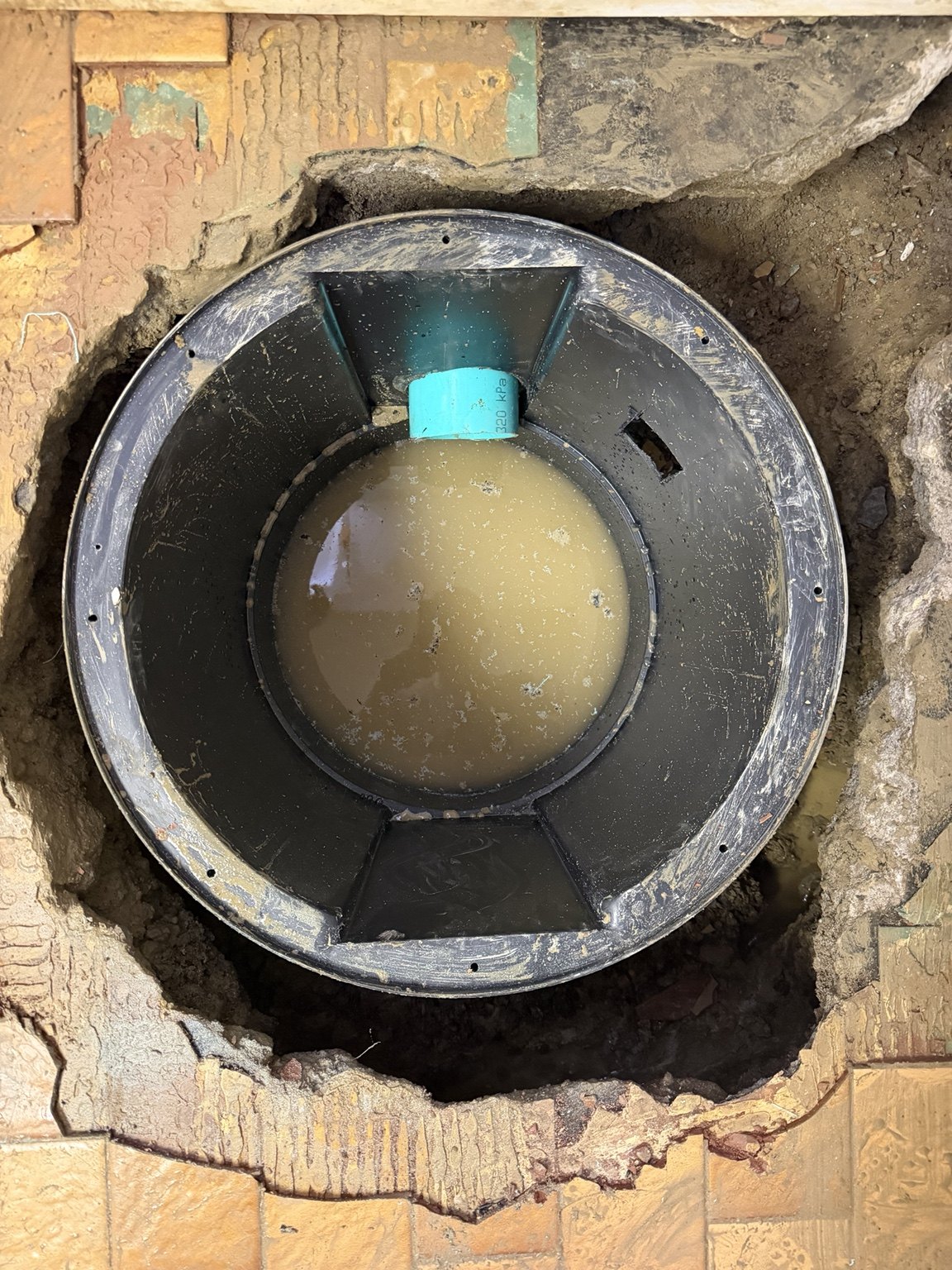 Basin positioned with the incoming drain pipe connected