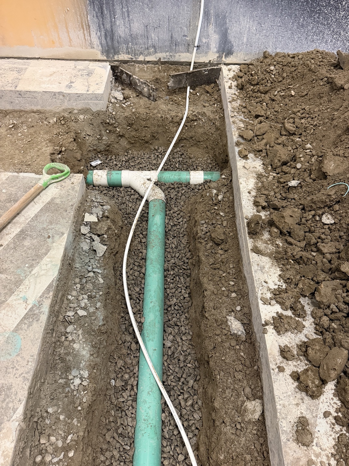 Exposed underground drain installation during excavation